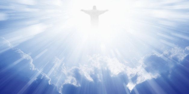 Jesus Christ in blue sky with clouds, bright light from heaven, resurrection, easter