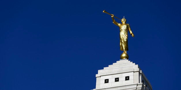 This July 14, 2015 photo, shows the Indianapolis Indiana Temple of The Church of Jesus Christ of Latter-day Saints, crowned with a gilded statue of the angel Moroni, in Carmel, Ind. The temple opens Friday, July 17 for three weeks of public tours before its dedication next month makes it off-limits to non-Mormons. (AP Photo/Michael Conroy)