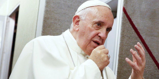 Pope Francis talks to journalists during a press conference he held while en route to Italy, Monday, Sept. 28, 2015. Pope Francis returned to the Vatican Monday at the end of a 10-day trip to Cuba and the United States. (Tony Gentile/Pool Photo via AP)