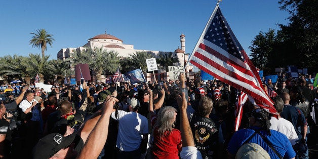 PHOENIX, AZ - MAY 29: Protesters and counter-protesters rally outside the Islamic Community Center on May 29, 2015 in Phoenix, Arizona. Crowds gathered in response to a planned 'freedom of speech' demonstration where attendees were encouraged to bring weapons and 'draw Mohammed'. (Photo by Christian Petersen/Getty Images)