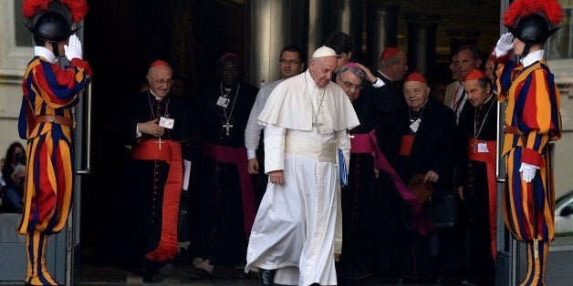 Pope Francis leaves at the end of the morning session of the Synod on the Family at the Vatican on October 5, 2015. Pope Francis said on October 5 that the Church was 'not a museum' but a place for progress, as members of a key synod started three weeks of debate aimed at reshaping Catholic teaching on the family. Francis urged a spirit of 'solidarity, courage and humility' as the Catholic Church's conservative and liberal wings began tackling hot-button topics from communion for remarried divorcees to acceptance of homosexuality. AFP PHOTO / TIZIANA FABI (Photo credit should read TIZIANA FABI/AFP/Getty Images)