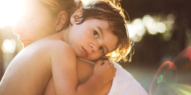 Small boy hugging his mother