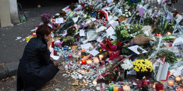 PARIS, FRANCE - NOVEMBER 16: A woman mourns the victims near the Bataclan concert hall on November 16, 2015 in Paris, France