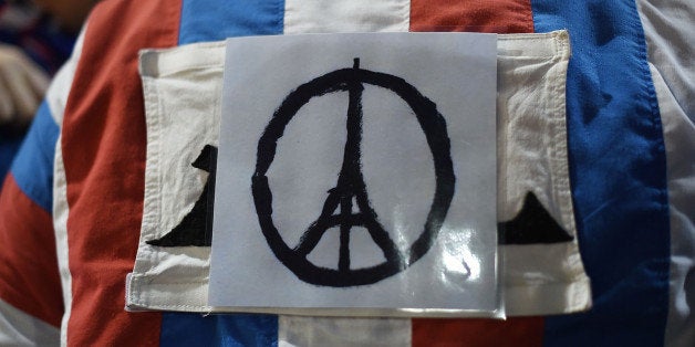 LONDON, ENGLAND - NOVEMBER 17: A french fan dressed in the colours of the french flag and adorned with the logo of the Eiffel tower, which was used after the Paris attacks, arrives ahead of tonight's International friendly match between England and France on November 17, 2015 in London, England. Security in London has tightened after a series of terror attacks across the French capital of Paris on Friday, leaving at least 129 people dead and hundreds more injured. (Photo by Ben Pruchnie/Getty Images)