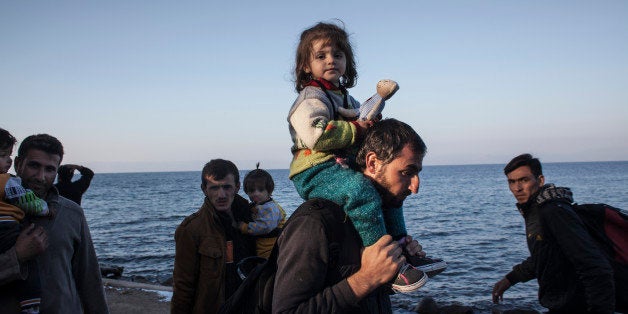 SKALA SIKAMINIAS, GREECE - NOVEMBER 05: Refugees from Afghanistan and Syria arrive in boats on the shores of Lesbos on November 5, 2015 near Skala Sikaminias, Greece. Lesbos, the Greek vacation island in the Aegean Sea between Turkey and Greece, faces a massive daily influx of migrants and refugees from Middle East countries. (Photo by Etienne De Malglaive/Getty Images)