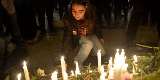 ISTANBUL, TURKEY - NOVEMBER 14: Turkish people leave flowers and candles in front of French embassy in Istanbul, Turkey to ex