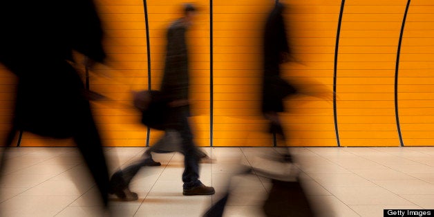 XXXL - motion blurred commuters against modern orange subway tube in background - tiled floor in foreground - this image is taken with a canon 5D mark II - processed from 16 bit RAW file in adobe photoshop and adobe colorspace - it is unsharped, professionally retouched to achieve the best possible image quality - special attention is given to color correction - lens correction: distortion & aberration