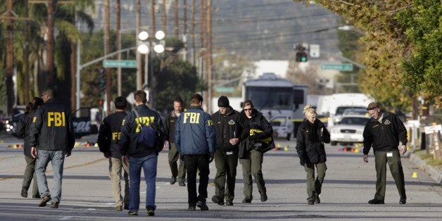 SAN BERNARDINO, CA - DECEMBER 3: Law enforcement personnel continue to investigate on San Bernardino Avenue, where two suspects in the mass shooting at the Inland Regional Center died in a shootout with police December 3, 2015 in San Bernardino, California. Investigators are looking for a motive as to why Syed Rizwan Farook and Tashfeen Malik went on a shooting rampage that left 14 dead and 17 others wounded. (Photo by Irfan Khan/Los Angeles Times via Getty Images)