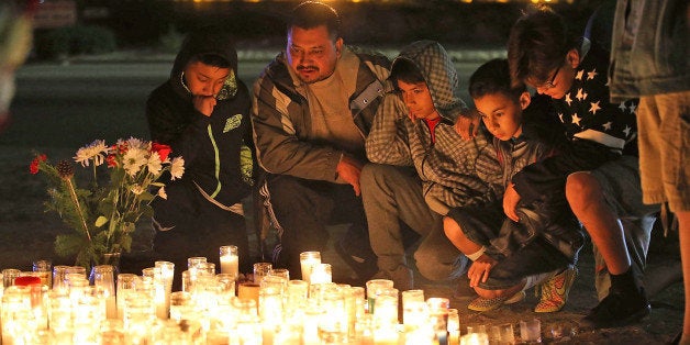 SAN BERNARDINO, CA - DECEMBER 04: Mourners visit a makeshift memorial near the Inland Regional Center on December 4, 2015 in San Bernardino, California. The FBI has officially labeled the attack carried out by Syed Farook and his wife Tashfeen Malik as an act of terrorism. The San Bernardino community continues to mourn the attack at the Inland Regional Center in San Bernardino that left at least 14 people dead and another 21 injured. (Photo by Justin Sullivan/Getty Images)