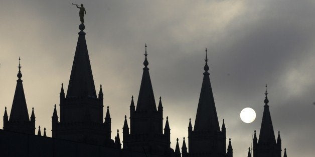 FILE - In this Feb. 6, 2013, file photo, the angel Moroni statue, silhouetted against a cloud-covered sky, sits atop the Salt