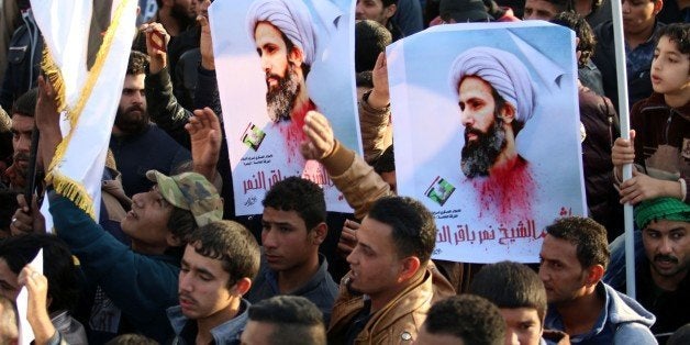 Supporters of Iraqi Shiite cleric Moqtada al-Sadr hold posters of prominent Shiite cleric Nimr al-Nimr during a demonstration