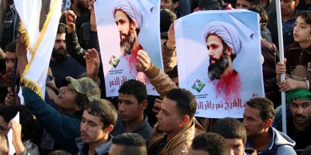 Supporters of Iraqi Shiite cleric Moqtada al-Sadr hold posters of prominent Shiite cleric Nimr al-Nimr during a demonstration in the southern Iraqi city of Basra on January 4, 2016, against Nimr's execution by Saudi authorities. Sunni-ruled Saudi Arabia severed diplomatic ties with Shiite-dominated Iran, its long-time regional rival, after angry demonstrators attacked the Saudi embassy in Tehran and its consulate following Nimr's execution. AFP PHOTO / HAIDAR MOHAMMED ALI / AFP / HAIDAR MOHAMMED ALI (Photo credit should read HAIDAR MOHAMMED ALI/AFP/Getty Images)