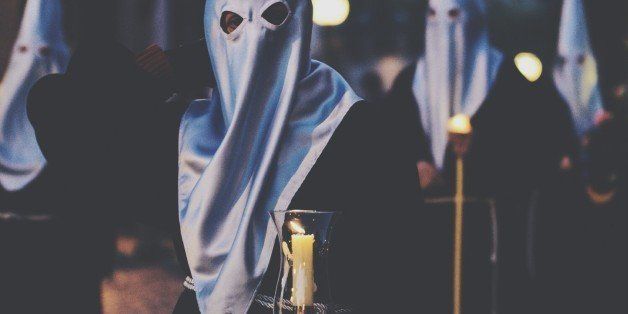 People Holding Lit Candle In Ku Klux Klan Rally