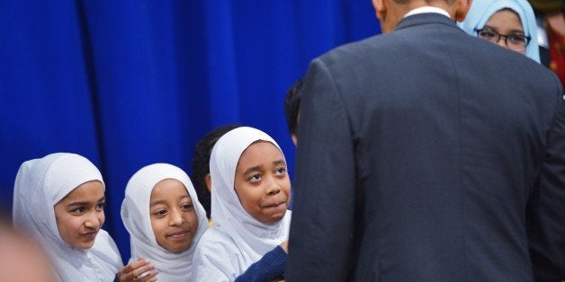Girls wait for their chance to greet US President Barack Obama at the Islamic Society of Baltimore, in Windsor Mill, Maryland