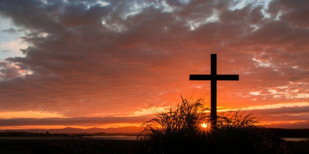 Cross on a hill as the morning sun comes up for the day.