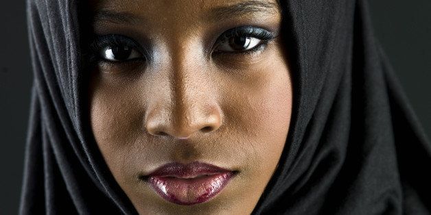 Beautiful muslim teenage girl posing on black background (this picture has been taken with a Hasselblad H3D II 31 megapixels camera)