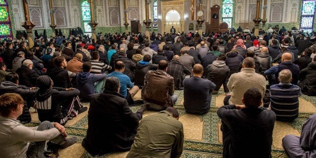 Muslim cleric Mouhameth Galaye (C) speaks ahead of Friday Prayers at the Grand Mosque in Brussels on Match 25, 2016, as Muslims gathered for the first Friday prayers in the wake of the suicide attacks at Brussels airport and a metro station that left 31 people dead and 300 wounded and were claimed by the Islamic State group. / AFP / PHILIPPE HUGUEN (Photo credit should read PHILIPPE HUGUEN/AFP/Getty Images)