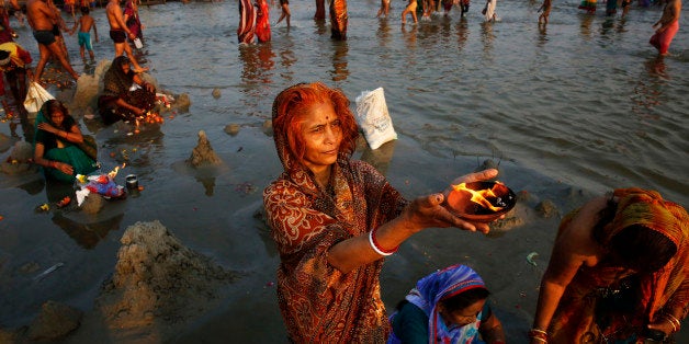 Indian women offer prayers at the 'Sangam', confluence of rivers Ganges, Yamuna, and mythical Saraswati, on the auspicious oc