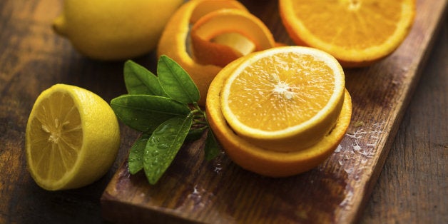 oranges and lemons over a wooden background