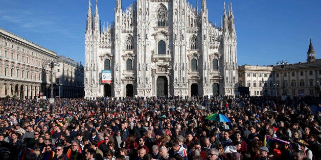 People gather in front of Milan's Duomo cathedral during a gay rights demonstration prior to a vote at the Italian parliament to change laws on recognition of rights for same-sex couples, in Milan, Italy, Sunday, Feb. 21, 2016. Italian premier Matteo Renzi has said that the government might considering resorting to a confidence vote to hasten approval of the law that will allow civil unions, but not marriage, for gay couples. (AP Photo/Antonio Calanni)