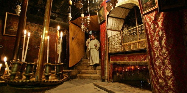 Catholic priests walk inside the Grotto, believed by Christians to be the birth place of Jesus, at the Church of the Nativity in the West Bank town of Bethlehem April 20, 2005. [Israelis and Jewish groups mostly praised the election of Pope Benedict XVI, saying he had atoned for his wartime membership in Nazi Germany's Hitler Youth by helping to champion Jewish-Catholic reconciliation. ]