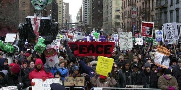 UNITED STATES - FEBRUARY 15: A sea of protesters, and one enormous papier-mache effigy of President Bush, fills First Ave. at 51st St. during a massive anti-war rally today. At least 100,000 demonstrators decrying a war with Iraq converged in the bitter cold throughout the day, jamming streets, stopping traffic and forming a mile-long river of people north of the United Nations. (Photo by John Roca/NY Daily News Archive via Getty Images)