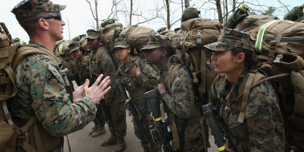 CAMP LEJEUNE, NC - FEBRUARY 22: Sgt. Jarrod Simmons tries to motivate his squad of Marines before they head out on a 10 kilometer training march carrying 55 pound packs during Marine Combat Training (MCT) on February 22, 2013 at Camp Lejeune, North Carolina. Since 1988 all non-infantry enlisted male Marines have been required to complete 29 days of basic combat skills training at MCT after graduating from boot camp. MCT has been required for all enlisted female Marines since 1997. About six percent of enlisted Marines are female. (Photo by Scott Olson/Getty Images)