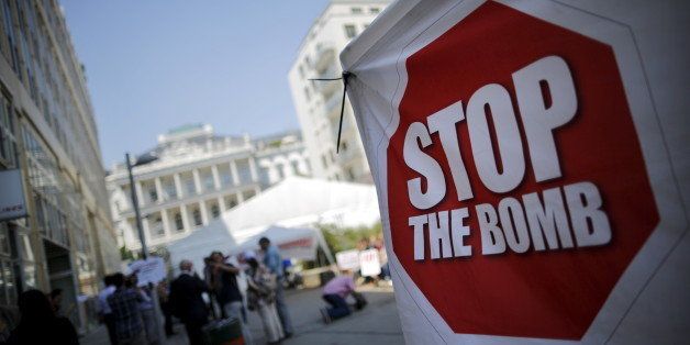 A sign which reads 'Stop the Bomb' is seen as protesters gather outside the hotel where the Iran nuclear talks meetings are being held in Vienna, Austria, July 1, 2015. International Atomic Energy Agency (IAEA) chief Yukiya Amano will be in Tehran on Thursday to discuss monitoring sensitive nuclear sites with senior officials as major powers and Iran seek a breakthrough in forging a lasting nuclear agreement. Iran and world powers gave themselves an extra week on Tuesday to reach an accord curbing Iran's nuclear programme in exchange for sanctions relief, but U.S. President Barack Obama warned there would be no deal if all pathways to an Iranian nuclear weapon were not cut off. REUTERS/Carlos Barria 