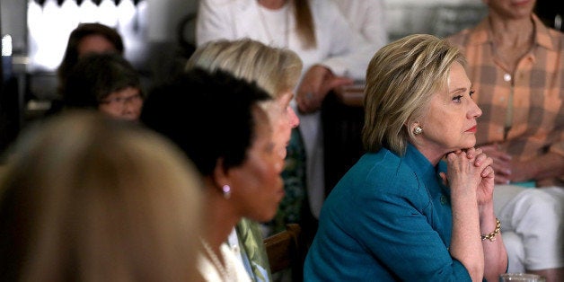 SANTA BARBARA, CA - JUNE 04: Democratic presidential candidate former Secretary of State Hillary Clinton (R) looks on during