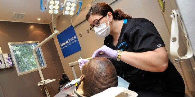 IMAGE DISTRIBUTED FOR ASPEN DENTAL - Army veteran Pruitt Bryant receives free dental care from Dr. Rachel Clay during the Aspen Dental HMM MouthMobile Atlanta Stop, on Tuesday, Sept. 8, 2015, in Atlanta. (John Amis/AP Images for Aspen Dental)