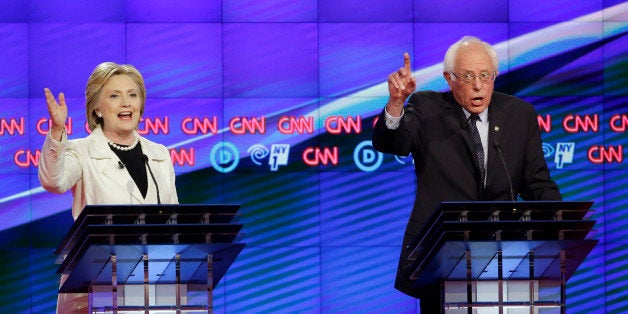 Democratic presidential candidates Sen. Bernie Sanders, I-Vt., right, and Hillary Clinton speak during the CNN Democratic Presidential Primary Debate at the Brooklyn Navy Yard on Thursday, April 14, 2016 in New York. (AP Photo/Seth Wenig)