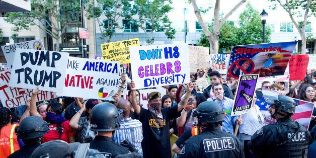 Police form a line to contain protesters outside a campaign rally for Republican presidential candidate Donald Trump on Thursday, June 2, 2016, in San Jose, Calif. (AP Photo/Noah Berger)