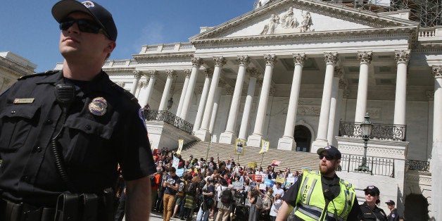 WASHINGTON, DC - APRIL 18: US Capitol Police give protesters a warning to move away from the front of the Capitol or get arrested, April 18, 2016 in Washington, DC. Protest groups Public Citizen and People for the American Way have been protesting the influence of money in politics over the last week, with more than 900 arrests reported. (Photo by Mark Wilson/Getty Images)