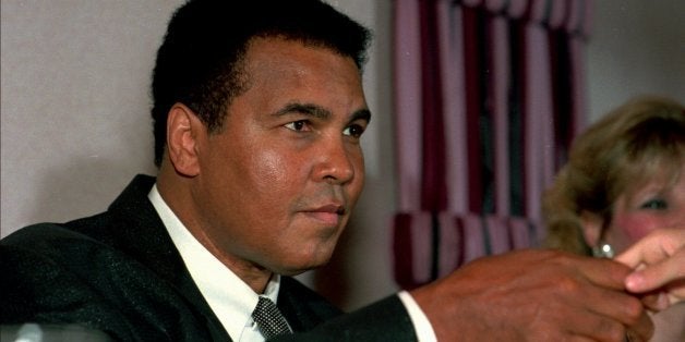 Muhammad Ali shakes the hand of a youngster during a dinner in the former champ's honor at the Ramada Inn in Lewiston, Maine,