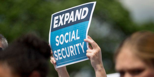 An 'Expand Social Security' sign is held up during a news conference with Bill de Blasio, mayor of New York, not pictured, outside of the U.S. Capitol building in Washington, D.C., U.S., on Tuesday, May 12, 2015. De Blasio unveiled 'The Progressive Agenda to Combat Income Inequality at the news conference.' Photographer: Andrew Harrer/Bloomberg via Getty Images