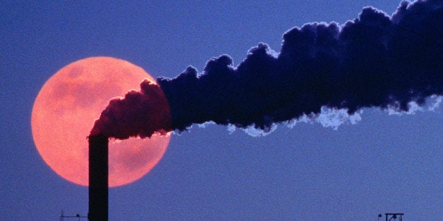 Smoke emerging from smokestack at chemical plant, evening