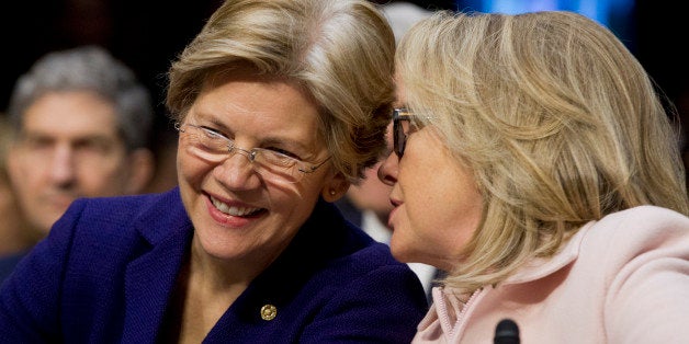 Senator Elizabeth Warren, a Democrat from Massachusetts, left, and U.S. Secretary of State Hillary Clinton talk during a Senate Foreign Relations Committee nomination hearing in Washington, D.C., U.S., on Thursday, Jan. 24, 2013. Senator John Kerry stressed the need to prevent Iran from acquiring nuclear weapons. He described the 'immediate, dangerous challenges' facing the nation as he seeks confirmation to become secretary of state. Photographer: Andrew Harrer/Bloomberg via Getty Images 