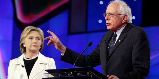 Democratic presidential candidate Sen. Bernie Sanders, I-V.t, right, speaks as Hillary Clinton listens during the CNN Democra