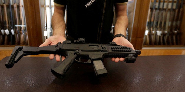 A salesman shows an assault rifle at Ceska Zbrojovka weapons factory shop in Prague, Czech Republic, May 31, 2016. REUTERS/