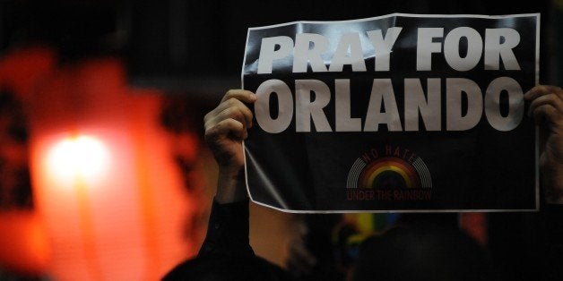 TOKYO, JAPAN - JUNE 14 : People pay tribute to victims of shooting at Pulse Nightclub in Orlando by holding banners and light
