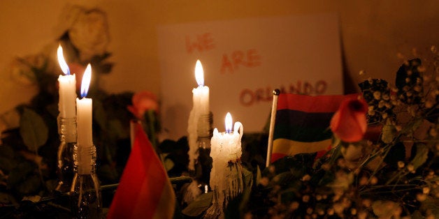 Candles lit by members of the LGBTQ community burn as they pay tribute to the victims of the mass shooting at the Pulse gay n