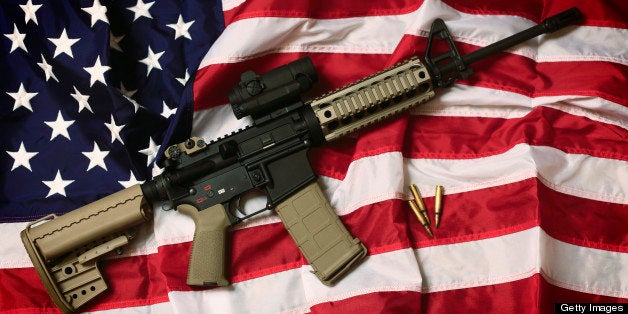 An AR-15 rifle with bullets on an American flag, a symbol of the right of patriotic Americans to bear arms, guaranteed by the Second Amendment.