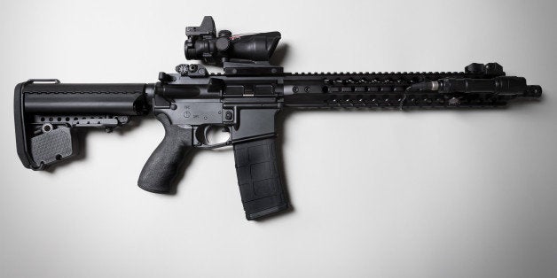 An ar-15 combat / assault rifle shot on a white backdrop with dramatic lighting.