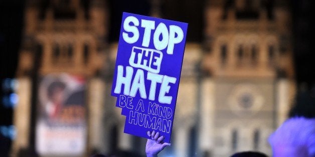 A protestor raises a placard as people gather at Federal Square to show their solidarity with the Orlando shooting victims, i