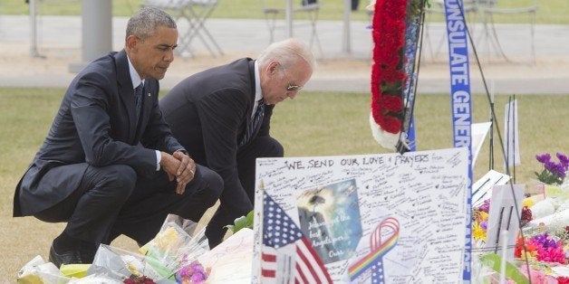 US President Barack Obama and Vice President Joe Biden place flowers for the victims of the mass shooting at a gay nightclub Sunday at a memorial at the Dr. Phillips Center for the Performing Arts in Orlando, Florida, June 16, 2016. / AFP / SAUL LOEB (Photo credit should read SAUL LOEB/AFP/Getty Images)