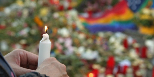 BERLIN, GERMANY - JUNE 18: A mourner attends a vigil for victims of a shooting at a gay nightclub in Orlando, Florida nearly a week earlier, in front of the United States embassy on June 18, 2016 in Berlin, Germany. Fifty people were killed and at least as many injured during a Latin music event at the Pulse club in the worst terror attack in the U.S. since 9/11. The American-born gunman had pledged allegiance to ISIS, though officials have yet to find conclusive evidence of his having any direct connection with foreign extremists. The incident has added fuel to the ongoing debate about gun control in the country. (Photo by Adam Berry/Getty Images)