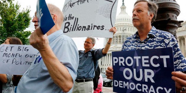 Supporters look on at a news conference led by Democratic senators and congressmen in support of a proposed constitutional amendment for campaign finance reform, on Capitol Hill in Washington September 8, 2014. REUTERS/Jonathan Ernst (UNITED STATES - Tags: POLITICS)