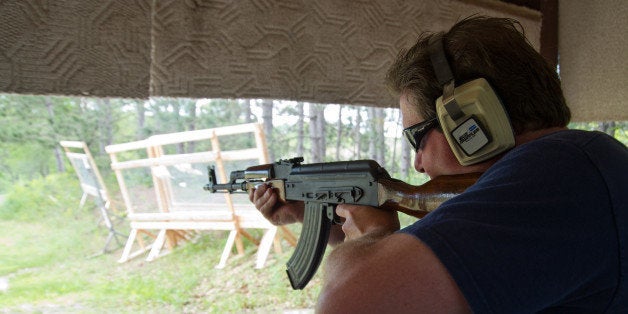 A man fires an AK-47 semi-automatic rifle June 3, 2012 at the St. Croix Rod and Gun Club in Hudson, Wisconsin. AFP PHOTO/Karen BLEIER (Photo credit should read KAREN BLEIER/AFP/GettyImages)