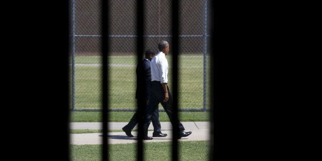 Photographed through a prison cell window, U.S. President Barack Obama tours the El Reno Federal Correctional Institution aft