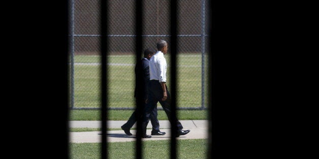 Photographed through a prison cell window, U.S. President Barack Obama tours the El Reno Federal Correctional Institution after Obama in El Reno, Oklahoma July 16, 2015. Obama is the first sitting president to visit a federal prison. REUTERS/Kevin Lamarque TPX IMAGES OF THE DAY 